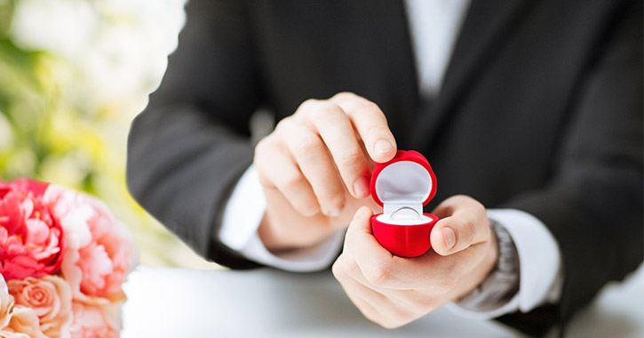 man proposing with red ring box