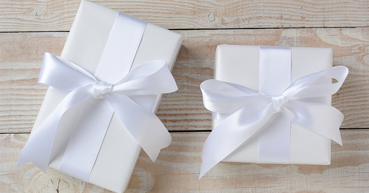 two white presents on wooden background