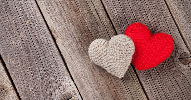 knit hearts on wooden background