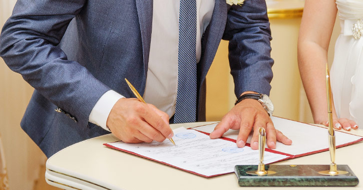 groom signing marriage license