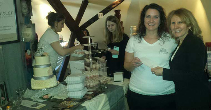 women with a table of confections