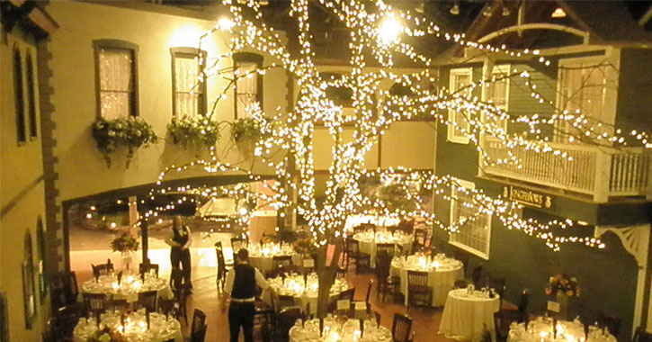 reception area with lighted tree in the middle and set tables