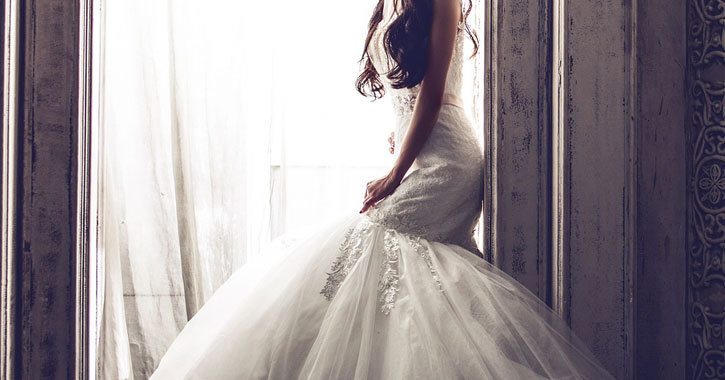a bride leaning against a wall