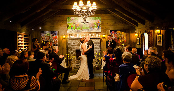 bride and groom kissing in front of guests