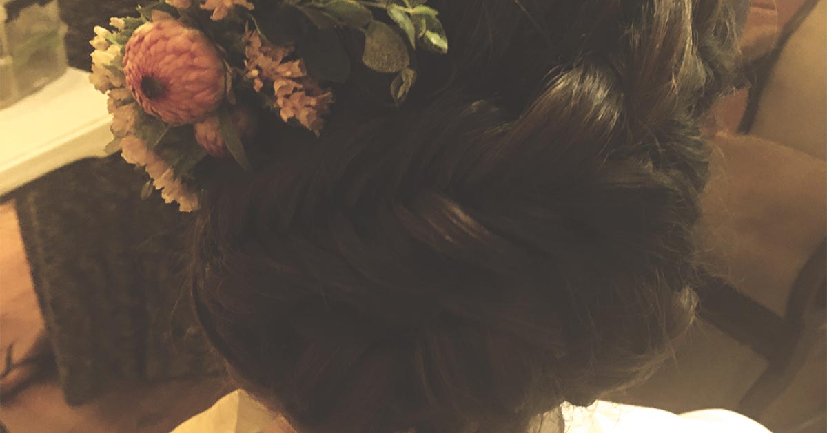 a braided updo with flowers