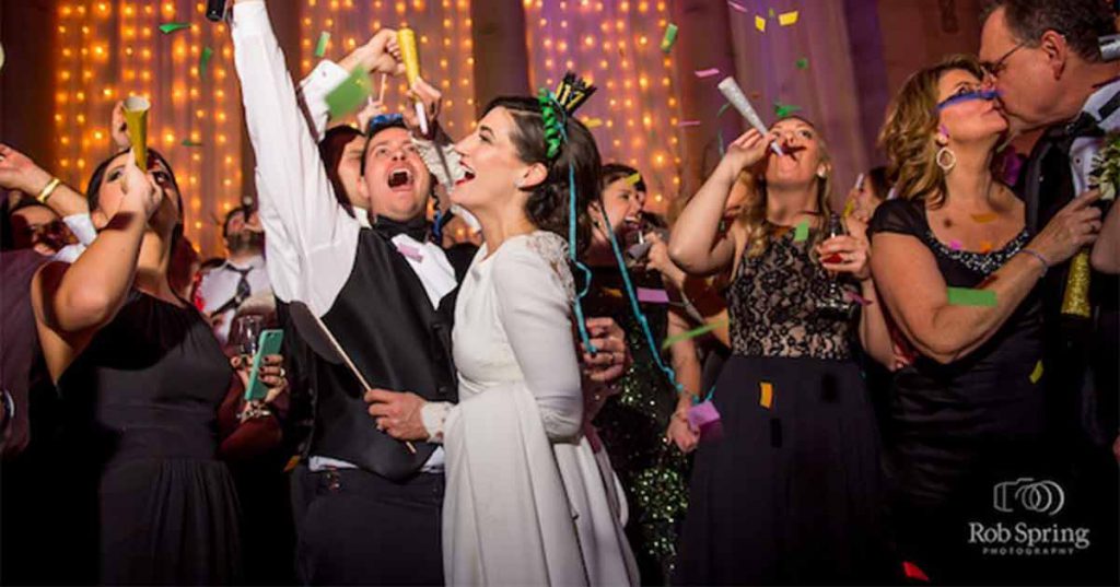 A couple and their guests celebrate at a reception