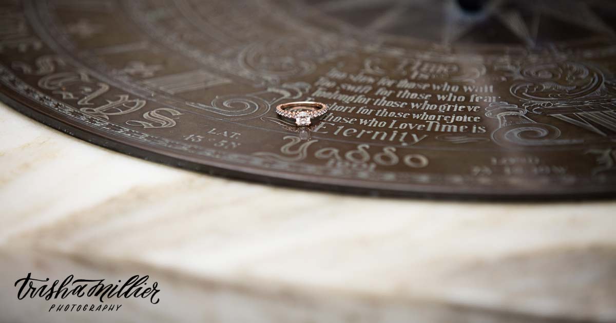 An engagement ring on a sundial at Yaddo