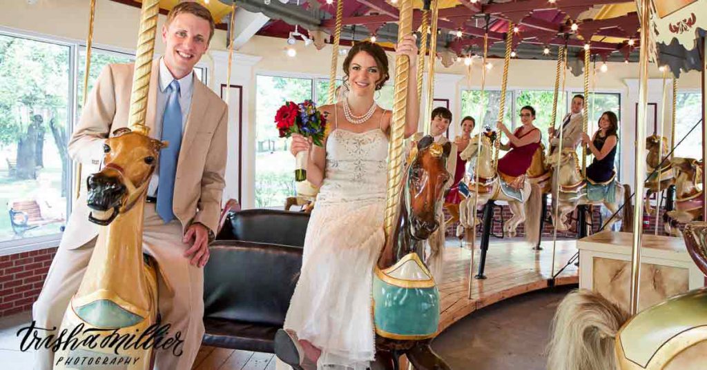 A wedding party rides the Congress Park Carousel.