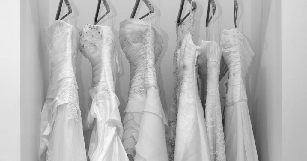 wedding gowns hanging up