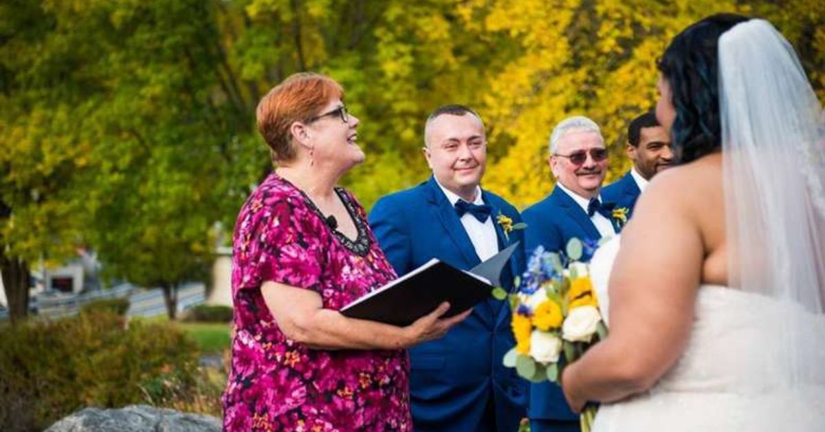 a female officiant speaking while others smile at the bride